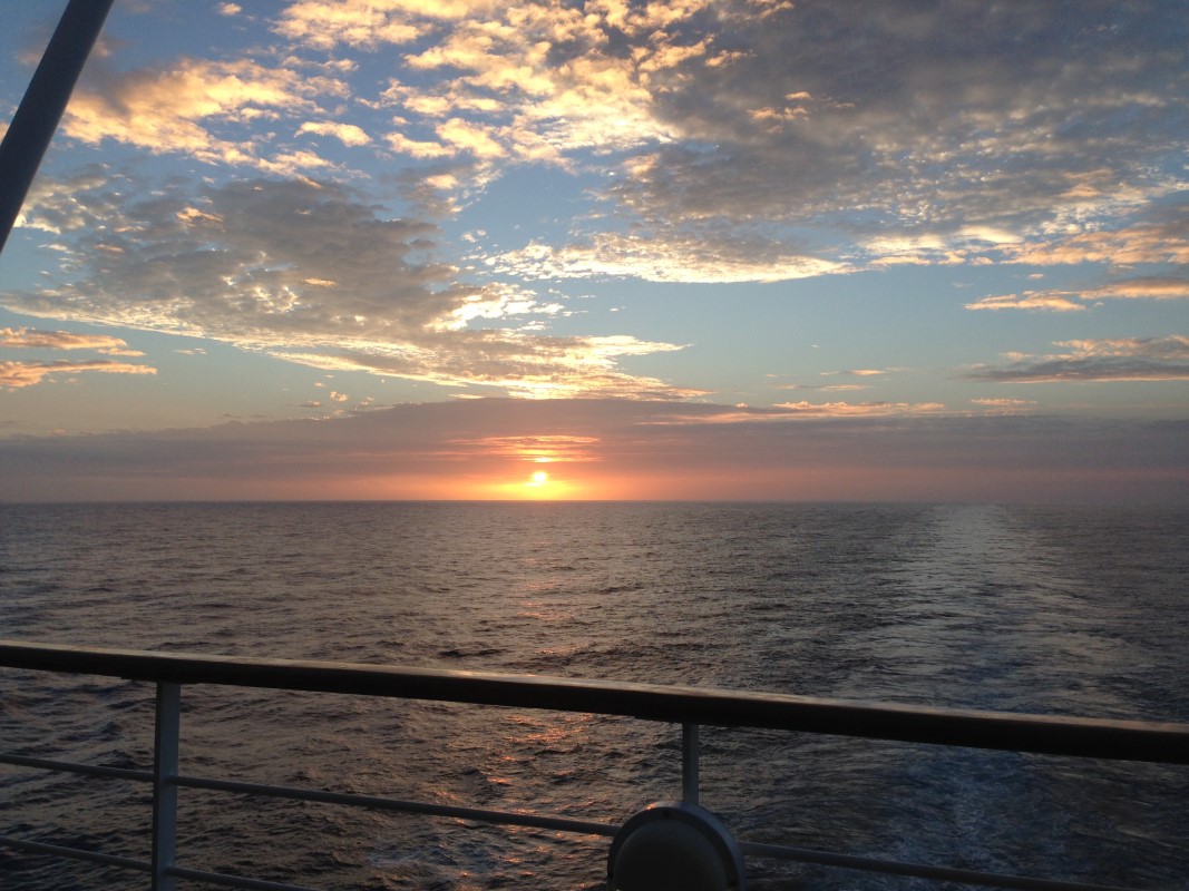 Picture of an orange hued hawaiin sunrise from a cruise ship.